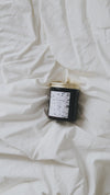 A video compilation of the 4000 candle, being lit, an old book being read, and coffee being poured.