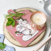 Sweet Mint in a copper tin, sitting on top of a chopping board with some cut herbs.