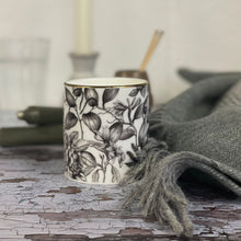  Sensual candle in a Bone China container printed with a hand-drawn illustration of the plants used in the fragrance, including patchouli, rose, and black pepper. Around the rim is a stripe of shiny 24k gold.