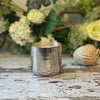 Rosemary & Coriander in a silver tin container, against a green and white floral background.