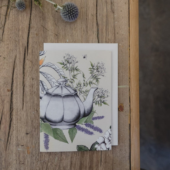 Card featuring a hand-drawn illustration of a teapot surrounding by florals.
