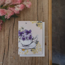  Card with a hand-drawn illustration of a teacup filled with flowers.